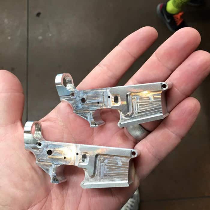 Small metal parts resembling gun lower receivers made from aluminum or lightweight metals.