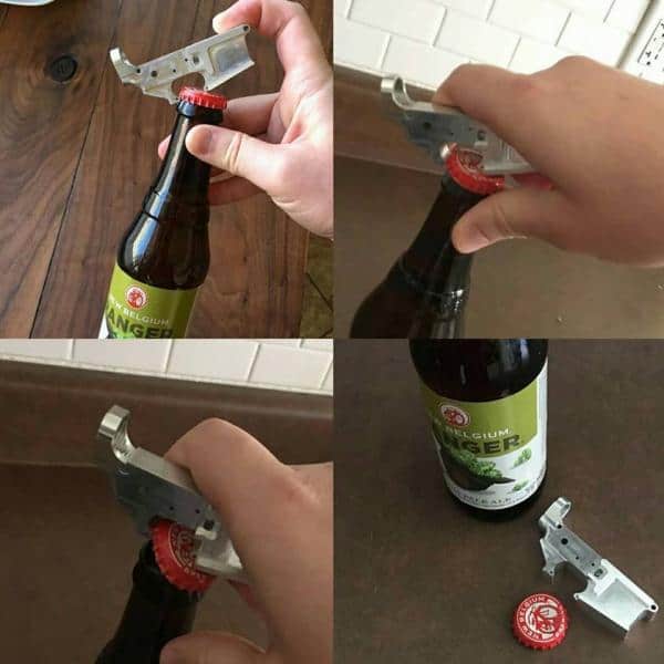 Mini metal bottle opener resembling a handgun, with creative design and functionality on display.