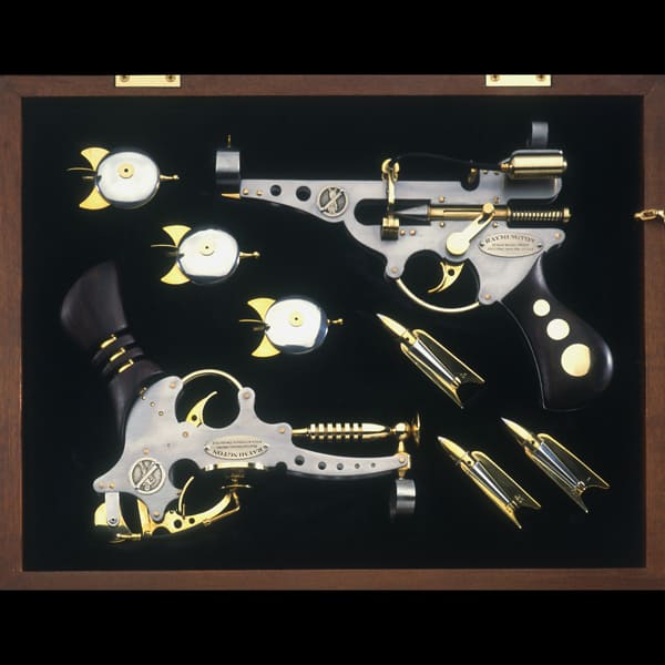Ornate pistols with gold accents on a dark background.