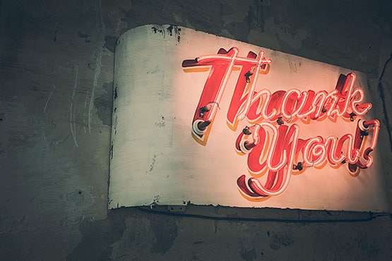 Stylized "Thank You" sign in red and yellow lettering.