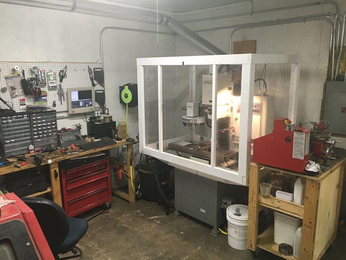 Well-equipped workshop with various tools and machinery.