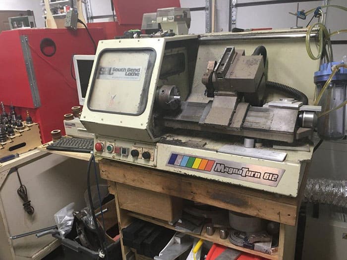 A South Bend Lathe MagnaTurn 612 in a machine shop or workshop setup.