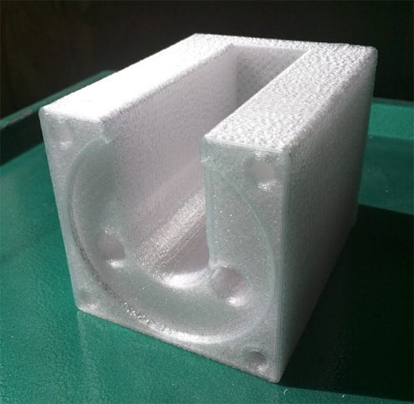 A rectangular block of white foam with a hollowed-out interior and a circular design.