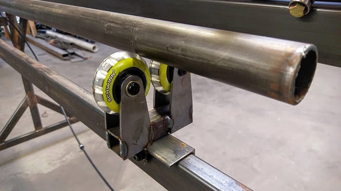 Metal rod with yellow and silver wheel attached.