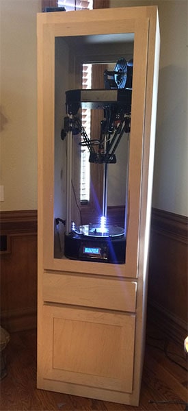 Tall wooden cabinet with glass doors and interior lit by blue lights.