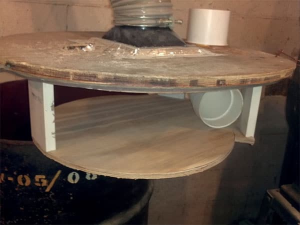 A large, circular disk with a central hole attached to a cylindrical device.