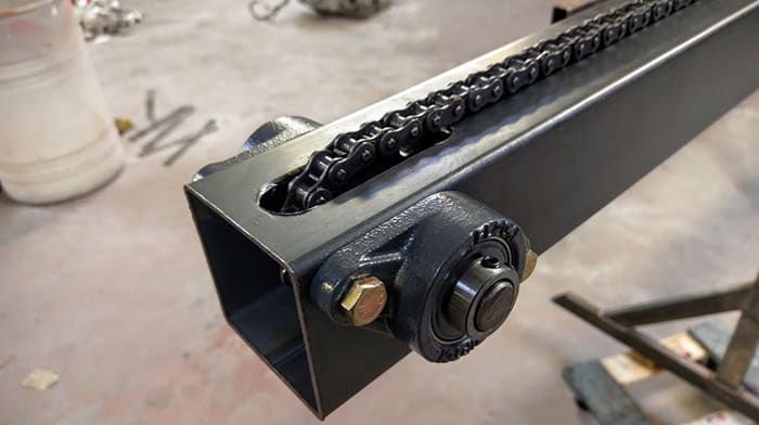 Metal part with bolt and chain.