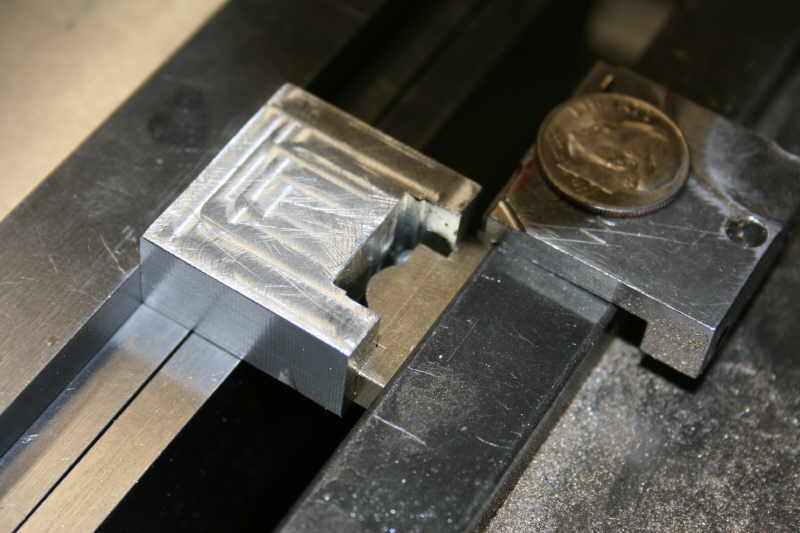 Metal beam with a silver-colored object attached.