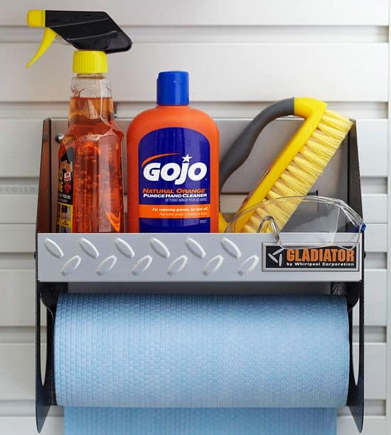 Gray caddy stocked with hand cleaner and safety goggles, mounted with paper towel roll.