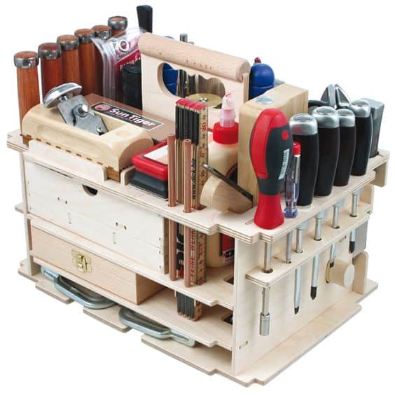 Wooden tool organizer with various tools stored inside, featuring multiple compartments and shelves holding wrenches, pliers, screwdrivers.