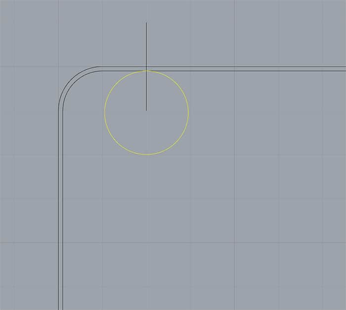 A 2D CAD drawing with gray background, curved lines, straight lines, and circular elements.