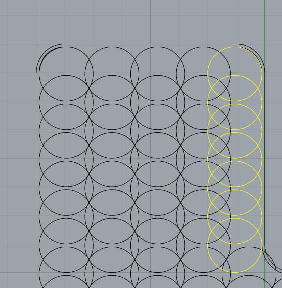 CAD design with grid of overlapping black and yellow circles on a gray background.