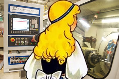 Cartoon blonde woman in front of a computer with 3D model on the screen.