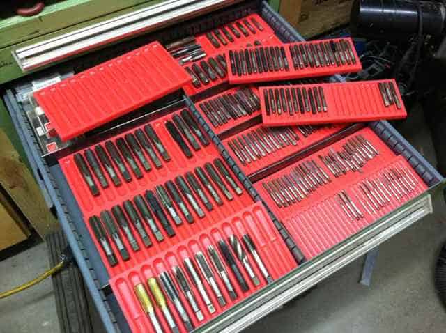 Red trays containing various tools, organized on a flat surface.