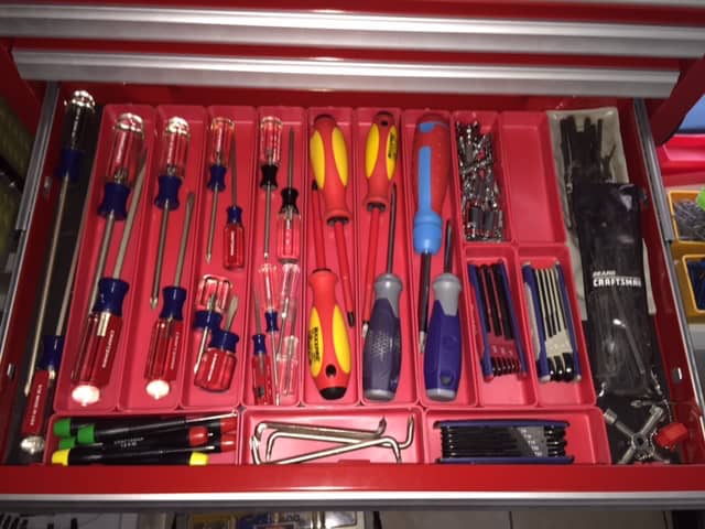 Tools neatly organized in a red tray.
