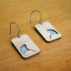 Stacked wooden or bamboo rectangles with rounded corners on thin wire hooks.