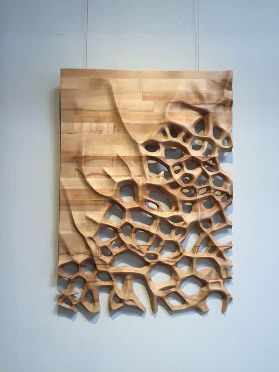 Wooden wall hanging with intricate, organic texture.