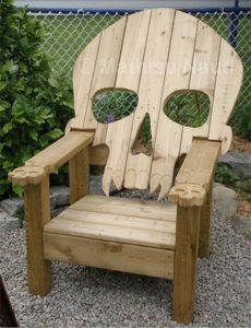 Wooden Adirondack chair with skull-shaped backrest and bone-like armrests.