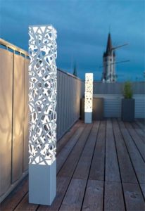 Sleek modern lighting fixture with geometric design and openwork pattern of interconnected circles.