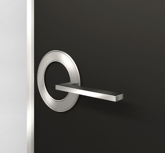 Sleek modern door handle made of brushed stainless steel on a dark grey background.