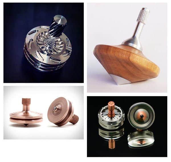 Various spinning tops made from traditional wooden and metal materials, with intricate carvings and a range of colors.