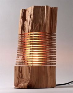 Unique wooden outdoor lighting fixture with cylindrical shape and hidden light source.