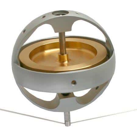 Precision gyroscopic device with metallic sphere on vertical axis.