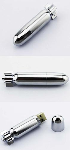 A silver cylindrical USB flash drive with a metallic finish at an angle.