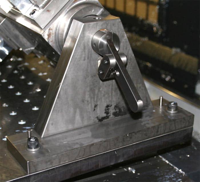 Metal tailstock component on a factory workshop floor.