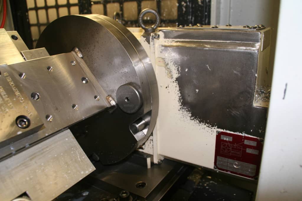 Metal component with features and attachments, multiple holes, and visible attachment points.