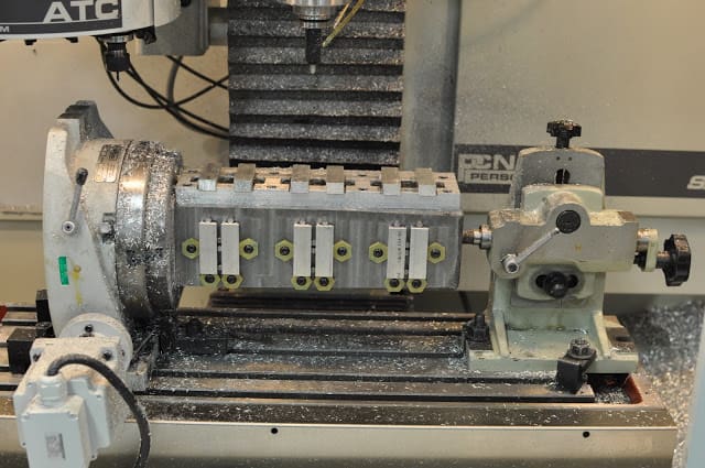 Large metal tombstone with multiple holes and cylindrical base.