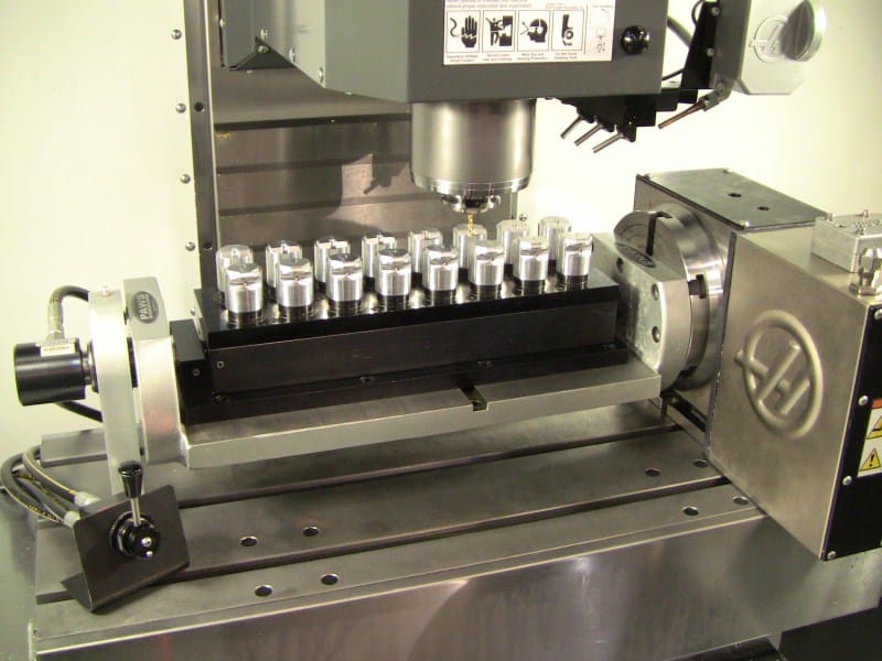 CNC milling machine with trunnion system and pneumatic holders.