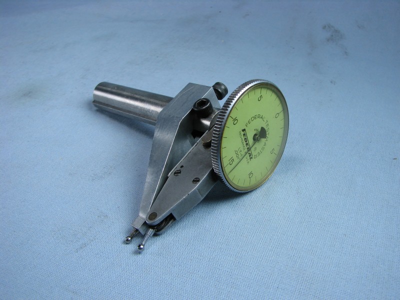 Dial indicator gauge for precise machining and manufacturing measurements.