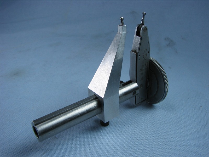 Precision measuring tool with dial face and Vernier scale.