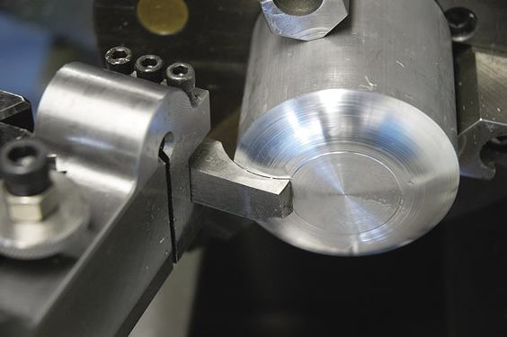 A close-up image of a metalworking tool showing intricate details and textures.