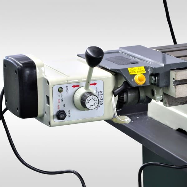 AS-236 power feed unit attached to a mill table, featuring control switch and speed dial.