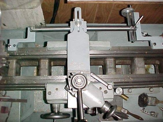Metalworking lathe taper attachment with attached metal rod.