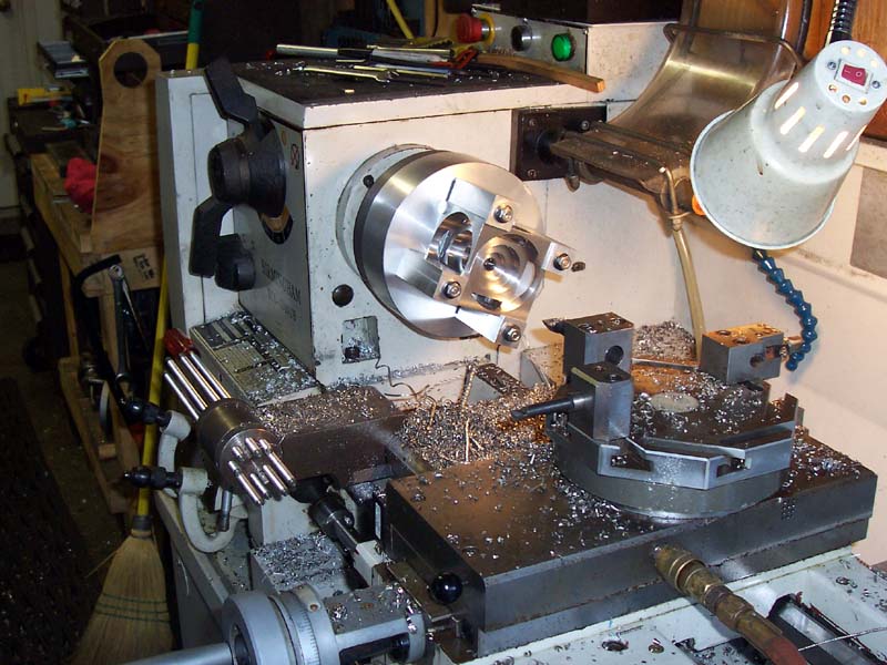 Industrial lathe with tools and attachments in a metalworking setting.
