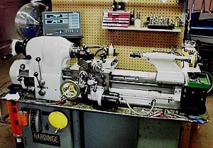 A Hardinge lathe machine on a gray base with dials, levers, and digital display screen.