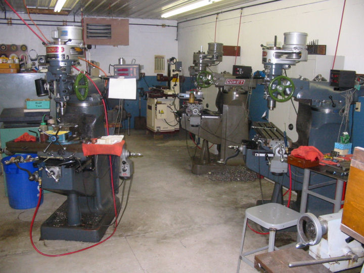Machine shop with drill press, milling machine, and metal fabrication tools.