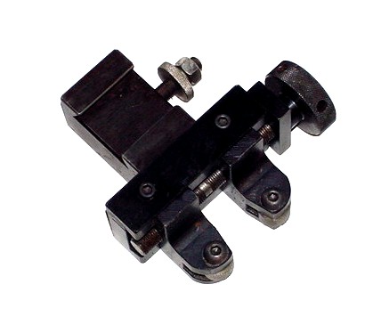 Black metal knurling tool with two prongs and small screw.