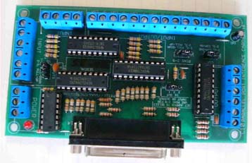 Green circuit board with components, resistors, capacitors, microchips, and blue connectors on a white background.