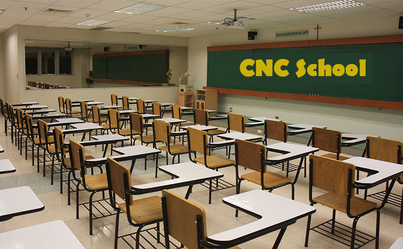 Empty classroom with rows of desks and chairs.