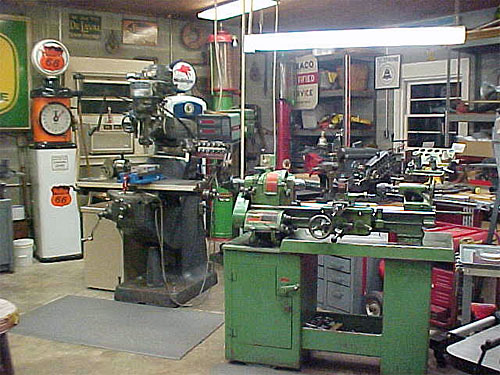 A modern machine shop with lathe, milling machine, and grinder.
