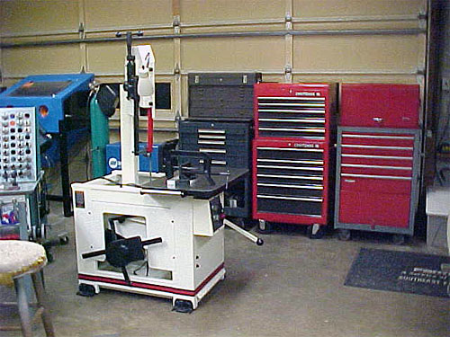 Well-organized garage with tools and machinery.