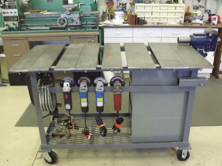 Mobile cart with three attached angle grinders in a cluttered workshop.