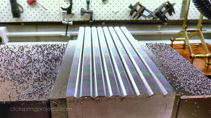 Large diameter fly cutter with fluted surface on a pegboard in a machine shop.