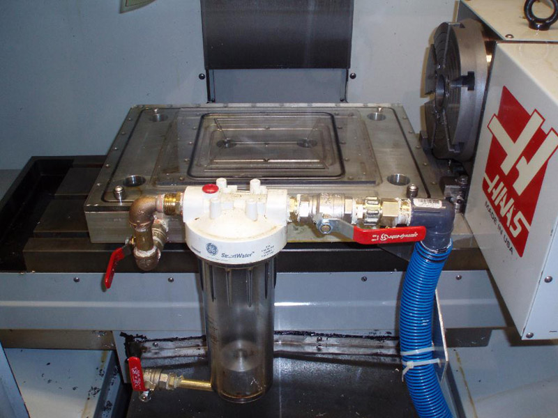 Industrial coolant trap system installed on machinery in a machine shop or metal fabrication facility.
