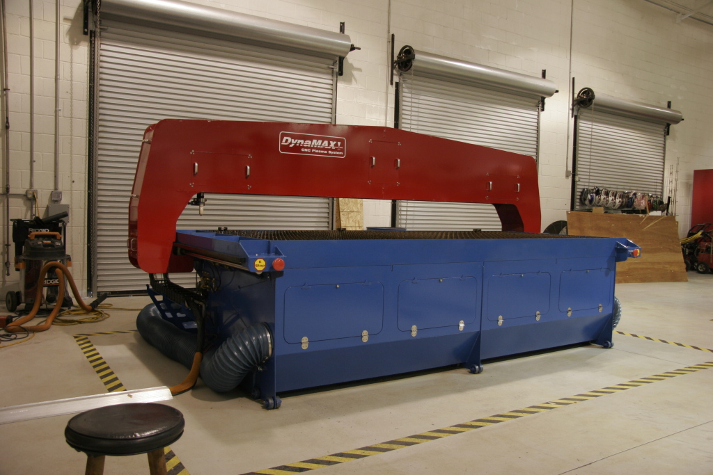 Red and blue DynaMAX 1 industrial machine in warehouse setting.