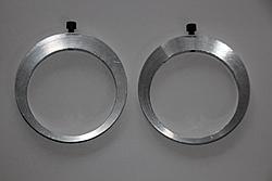 Two eccentric-shaped metal rings on a light gray background.